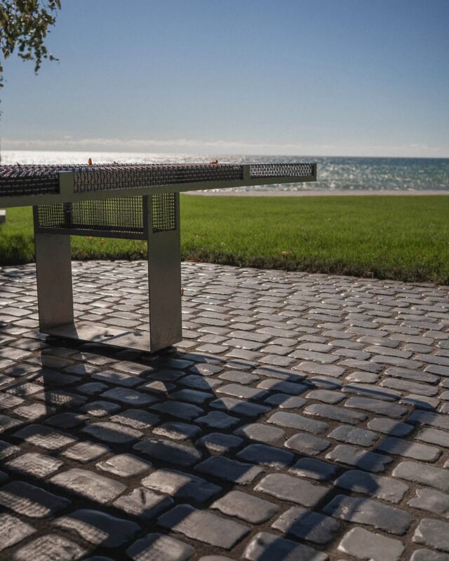 A minimalist landscape embracing modern aesthetics and a stunning lakeside view. Landscape Build: County Landscape & Excavation CoLandscape Design: @stacklab_design Photography: @onelookrealestate #cobblestone #unilock #landscapedesign #lakesideview #pec #princeedwardcounty #wellington #countylandscape #rootedquality